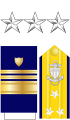 <p>The collar device is three silver five-pointed stars. The shoulder board is gold with three silver stars.</p>