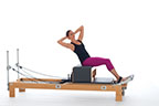 <p><strong>Setup</strong></p><ul><li><p>Starting in Flat Back position (page 31)</p></li><li><p>Resistance: <strong>all springs attached to hold carriage in place</strong></p></li></ul><p><strong>Movement</strong></p><ul><li><p>Inhale: Rotate trunk, lower trunk diagonally back</p></li><li><p>Exhale: Lift trunk to center, rotate to front, return to start position</p></li><li><p>Inhale: Rotate trunk, lower trunk diagonally back to opposite side</p></li><li><p>Exhale: Lift trunk to center, rotate to front, return to start position</p></li><li><p>Alternate sides</p></li></ul><p><strong>Muscle Focus</strong></p><ul><li><p>Spinal rotators</p></li><li><p>Spinal flexors</p></li><li><p>Spinal extensors</p></li><li><p>Hip flexors</p></li></ul><p><strong>Objectives</strong></p><ul><li><p>Spinal rotator strength</p></li><li><p>Trunk stabilization</p></li><li><p>Hip flexor strength</p></li></ul><p><strong>Cues</strong></p><ul><li><p>Maintain co-contraction of abdominals and back extensors</p></li><li><p>Keep both sit bones in contact with box</p></li><li><p>Rotate on longitudinal axis prior to hinging diagonally back</p></li><li><p>Return to longitudinal axis prior to facing front</p></li></ul><p></p>