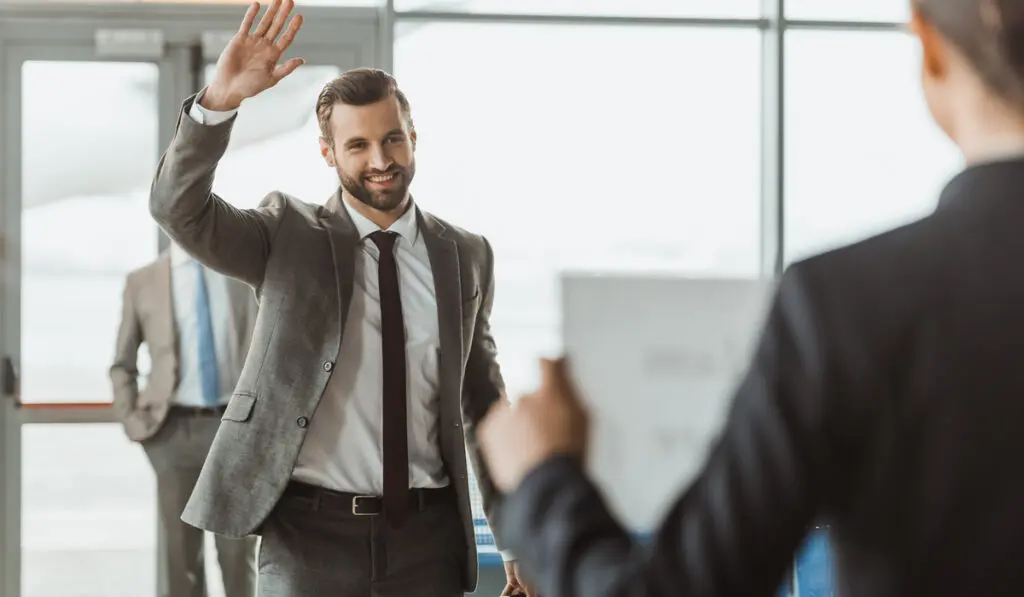 <p>hint: greeting with people officially </p>