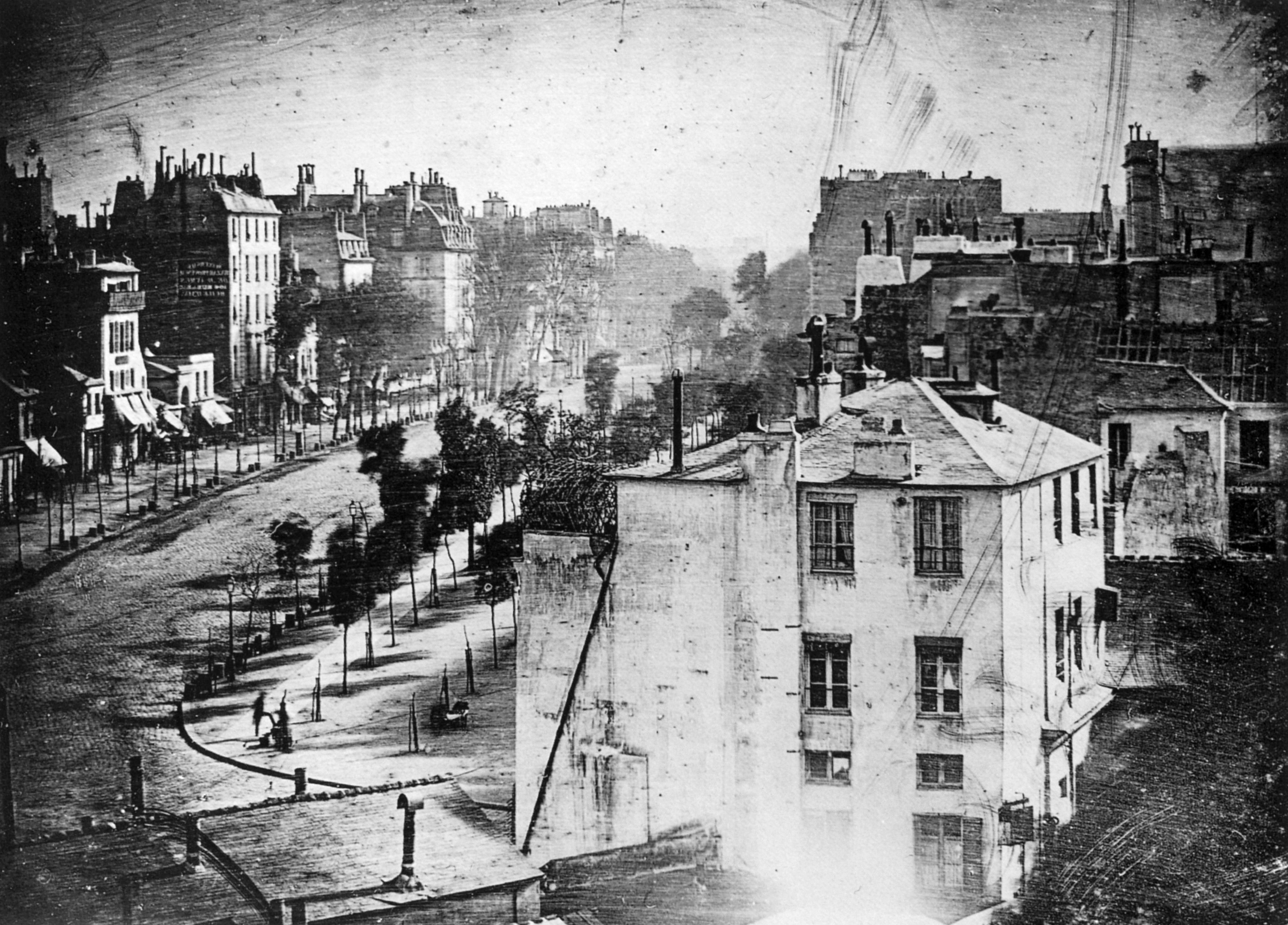 <p>daguerrotype- photo process that requires metal plates and chemicals; long exposure time so people moved too quickly to get captured; still the first person to be captured is in this photo</p>