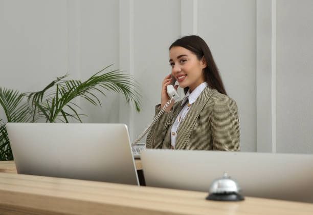 A receptionist usually a______ t___ p_____ in an office.