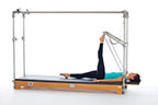 <p><strong>Setup</strong></p><ul><li><p>Lying supine, toes of one foot placed on PTBar, leg bent, other leg placed on mat, leg straight, foot plantarflexed</p></li><li><p>Resistance: medium <strong>[bottom loaded] 1 spring + safety belt</strong></p></li></ul><p><strong>Movement</strong></p><ul><li><p>Exhale: Straighten leg</p></li><li><p>Inhale: Bend leg, return to start position</p></li></ul><p><strong>Muscle Focus</strong></p><ul><li><p>Hip extensors</p></li><li><p>Knee extensors</p></li></ul><p><strong>Objectives</strong></p><ul><li><p>Hip extensor strength and stretch</p></li><li><p>Hip flexor stretch (supporting leg)</p></li><li><p>Knee extensor control</p></li><li><p>Foot alignment and stabilization</p></li><li><p>Pelvic lumbar stabilization</p></li></ul><p><strong>Cues</strong></p><ul><li><p>Establish maximum plantarflexion when leg is straight</p></li><li><p>Keep heel stable, moving around ankle joint</p></li><li><p>Maintain pelvic lumbar stabilization</p></li><li><p>Maintain hip extensor engagement</p></li><li><p>Straighten leg completely, avoiding hyperextension</p></li></ul><p></p>