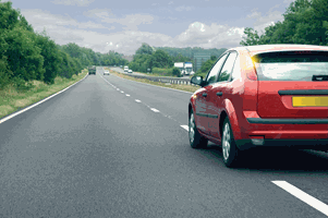 <p><span>You’re driving along this road. What should you do if the red car cuts in close in front of you?</span></p>