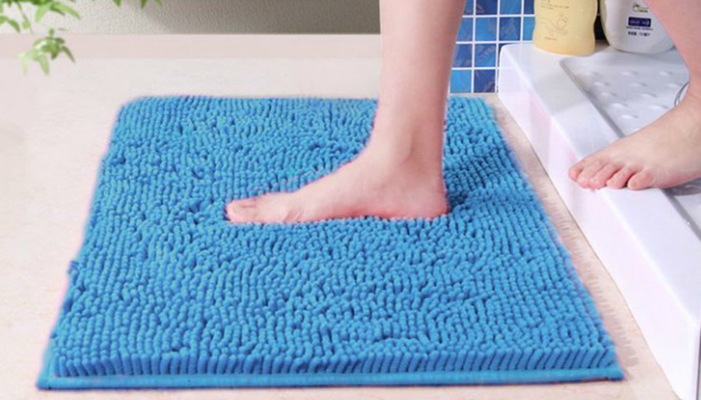 <p>A piece of material placed on the floor next to a bath or shower to absorb water.</p><p>Example: Step onto the bath mat so you don't slip on the wet floor.</p>