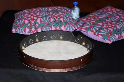 <ul><li><p>flat round drum</p></li><li><p>had jingles around it like tamburine</p></li></ul><p></p><p></p>