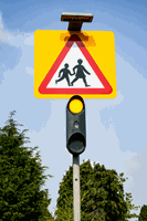 <p>What action should you take when you see flashing amber lights under a school warning sign?</p>