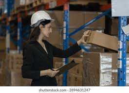 <p>The woman is inspecting a packet.</p>