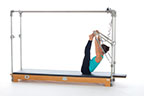 <p><strong>Setup</strong></p><ul><li><p>Lying supine, arms straight and shoulder width apart , hands holding PTBar, legs bent, toes placed on PTBar, feet hip width apart and plantarflexed</p></li><li><p>Resistance: Meduim/Heavy <strong>[bottom loaded] 1 or 2 springs + safety belt</strong></p></li></ul><p><strong>Movement</strong></p><ul><li><p>Exhale: Roll up, simultaneously, straighten legs</p></li><li><p>Inhale: Dorsiflex and plantarflex feet</p></li><li><p>Exhale: Roll down, simultaneously bend legs, return to start position</p></li></ul><p><strong>Muscle Focus</strong></p><ul><li><p>Spinal flexors</p></li><li><p>Spinal extensors</p></li><li><p>Hip extensors</p></li><li><p>Ankle-foot plantarflexors</p></li></ul><p><strong>Objectives</strong></p><ul><li><p>Spinal flexor control</p></li><li><p>Spinal extensor control</p></li><li><p>Hip extensor and ankle-foot plantarflexor stretch</p></li></ul><p><strong>Cues</strong></p><ul><li><p>Initiate movement with abdominals</p></li><li><p>Maintain plantarflexion while rolling up and down</p></li><li><p>Engage back extensors in pike position</p></li><li><p>Maintain scapular stabilization</p></li></ul><p></p>