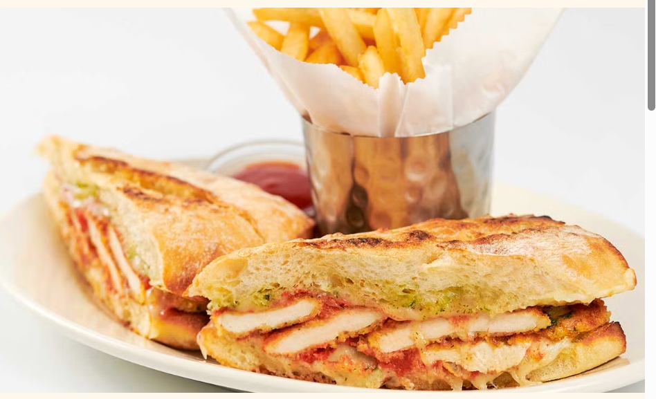 <p>Tender Chicken Lightly Coated in Parmesan Breadcrumbs, Tomato Sauce and Melted Cheese on a Freshly Grilled French Roll</p>