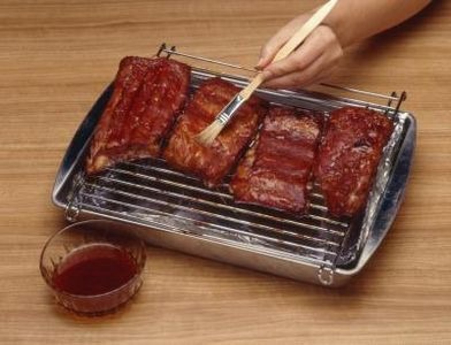 <p>To cover with melted fat, gravy, while cooking.ato pour or spoon liquid over food as it cooks to moisten and flavor it</p>