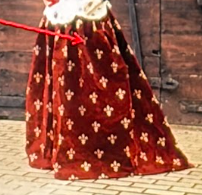 <p>A long outer garment worn over a gown with large openings at the sides - The Late Middle Ages</p>