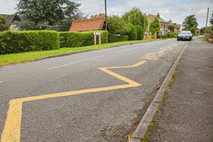 <p>The road outside this school is marked with yellow zigzag lines. What do these lines mean?</p>