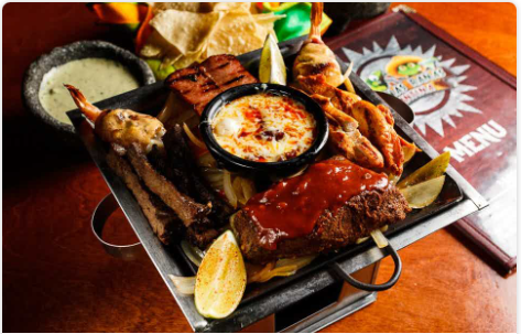 <p>Beef and chicken fajitas, sausage, carnitas, and (2) brochette shrimp. Served with guacamole, pico de gallo, sour cream, shredded cheese, rice, your choice of beans, and a small portion of our creamy wine sauce mixed with chorizo.</p>