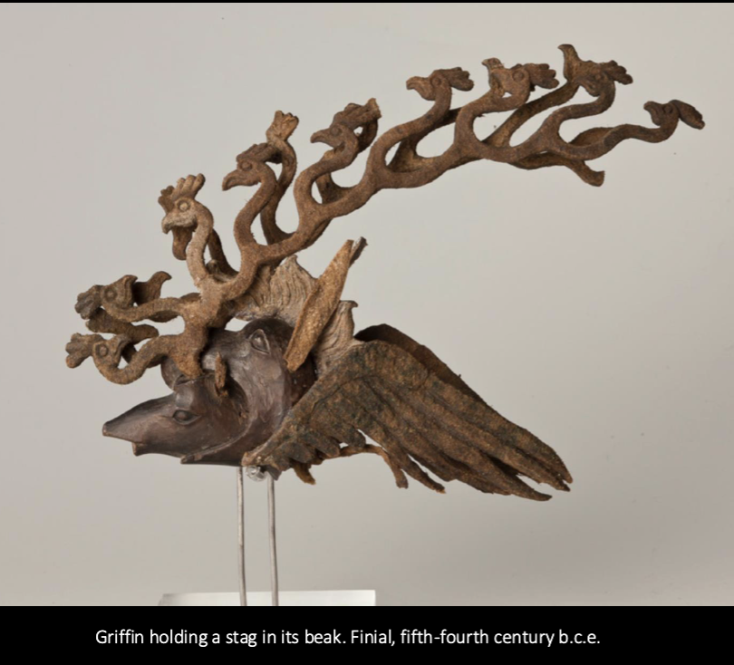 <p><span>Griffin holding a wooden stag in its beak</span></p>