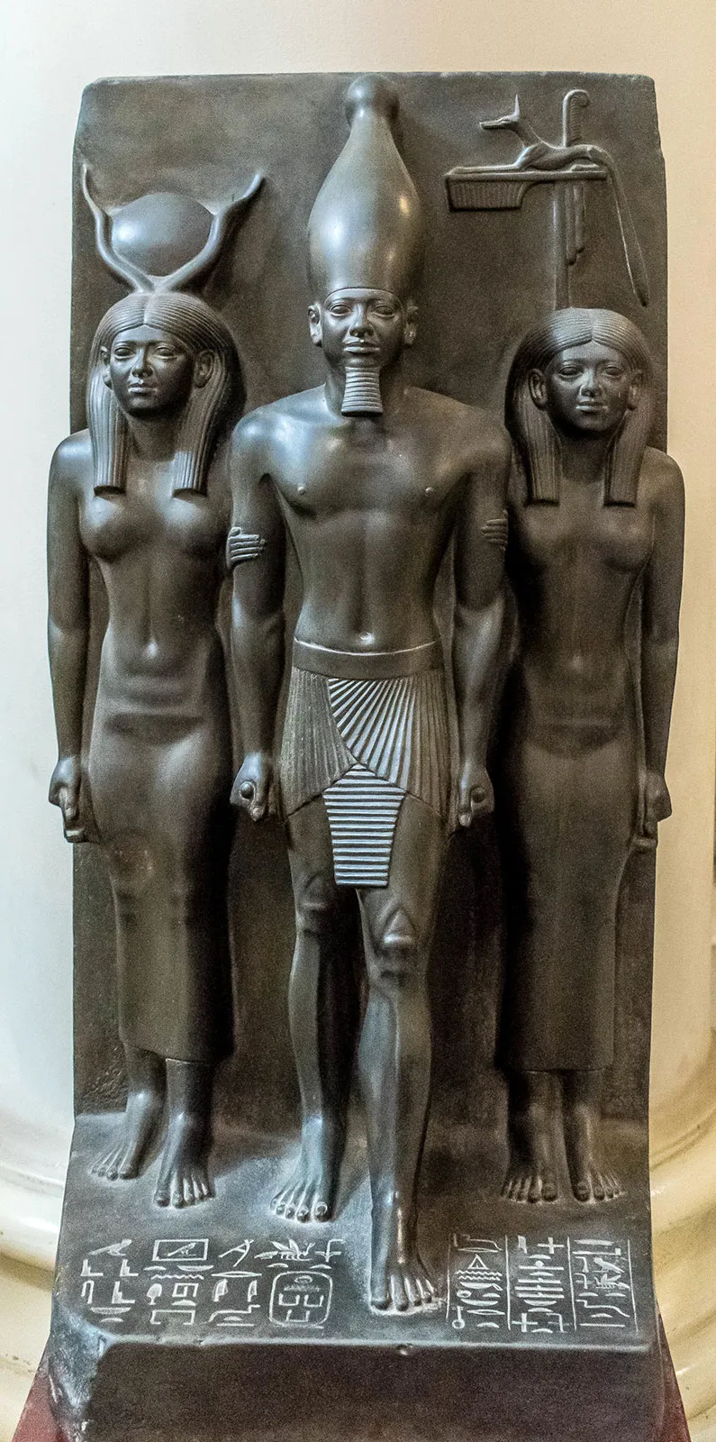 <p><span style="background-color: transparent;"><strong>2500 BCE / Old Kingdom Ancient Egypt</strong></span></p><ul><li><p><span style="background-color: transparent;">Smooth, dark greywacke, polished to a silky finish that conveys eternity and immortality&nbsp;</span></p></li><li><p><span style="background-color: transparent;">Menkaure wears the striped nemes headdress, a false beard and a pleated kilt, and holds cloth rolls in his clenched fists.</span></p></li><li><p><span style="background-color: transparent;">His body is broad-shouldered and eternally youthful, but his face is individualized, with prominent eyes, a fleshy nose, rounded cheeks and a full mouth.</span></p></li><li><p><span style="background-color: transparent;">Her body is similar to his, broad stance, foot forward, quite unnatural position&nbsp;</span></p></li><li><p><span style="background-color: transparent;">To ensure the king's rebirth in the afterlife and to serve as a focus of worship in his funerary cult.</span></p></li><li><p><span style="background-color: transparent;">Symbolises eternal royal authority, marital unity and the divine partnership required to sustain pharaonic rule&nbsp;</span></p></li><li><p><span style="background-color: transparent;">Posture is hallmark of ancient Egyptian art</span></p></li></ul><p></p>