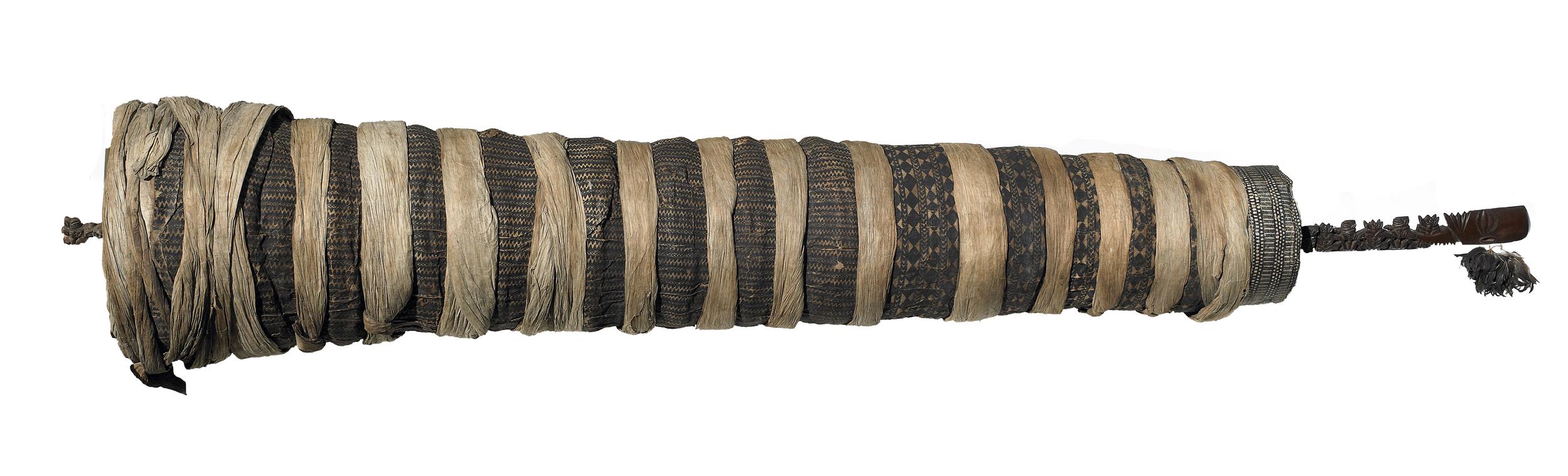 <p>A wooden core carved with ancestral figures, wrapped in barkcloth to keep its intense spiritual power safe inside.</p>