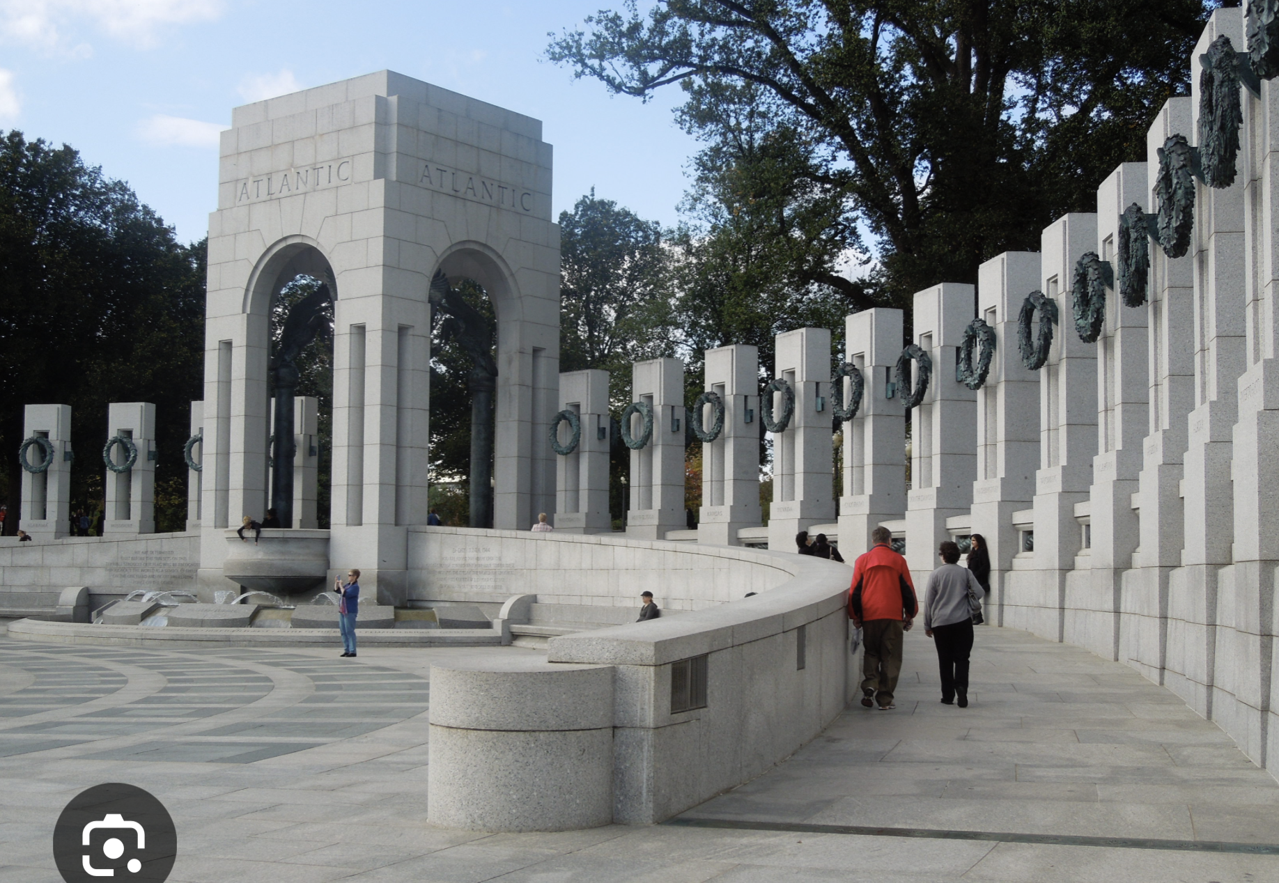 <p>Washington, D.C. WWII Memorial, 2002, arch.: Friedrich St. Florian</p><ol><li><p><span><strong>Honoring the "Greatest Generation" and Sacrifice:</strong> The memorial, located on the National Mall, serves as the premier national site for honoring the 16 million who served, over 400,000 who died, and the millions who supported the war effort from home.</span></p></li><li><p><span><strong>Symbolic Architecture of Unity:</strong> Architect Friedrich St. Florian designed a classical,, 7.4-acre plaza with 56 pillars and two massive triumphal arches (Pacific and Atlantic) linked by bronze ropes to represent the unprecedented unity of American states and territories.</span></p></li><li><p><span><strong>The Freedom Wall and Home Front Recognition:</strong> The memorial features the Freedom Wall containing 4,048 gold stars, each representing 100 American deaths, along with 24 bronze bas-relief panels that narrate both battle scenes and, significantly, the industrial and agricultural transformation of the American home front.</span></p></li></ol><p></p>