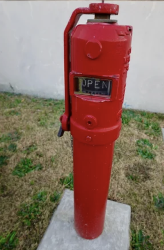 <p>what valve has a hollow metal post that houses the valve stem with a movable plate with the words OPEN or SHUT visible through a small glass window on the side of the housing?</p>