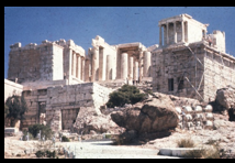 <p>Mnesikles, <em>The Propylaea</em>, Acropolis, Athens, ca. 437-432 B.C.E.</p><p><span>The <u>Acropolis</u> is really an <u>ensemble of structures</u> built during the <u>classical period </u>on a plateau above Athens</span></p><p><span>•<u>Propylaea = entry gate </u>to the complex, reached after climbing a steep, winding slope; this was the path of the <u>Panathenaic Procession</u></span></p><p><span>•Remained unfinished due to financial drain of the Peloponnesian War</span></p><p><span>•Flanking building were supposed to contain library and the first picture gallery (<em>Pinakotheke</em>) in history; notice small temple to the far right</span></p><p></p>