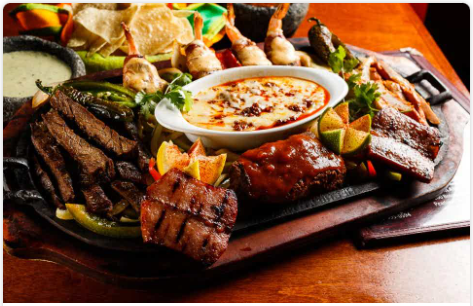 <p>Beef and chicken fajitas, sausage, carnitas, and (4) brochette shrimp. Served with guacamole, pico de gallo, sour cream, shredded cheese, rice, your choice of beans, and a small portion of our creamy wine sauce mixed with chorizo.</p>