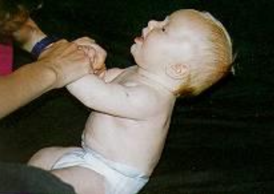<p>when does this reflex occur? - pulls to sit</p>