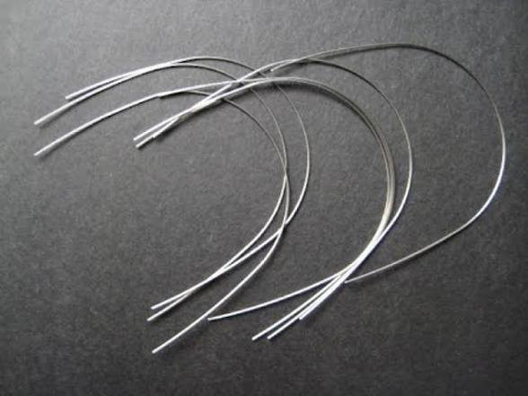 <p>A pre-shaped metal wire with dental braces to fit the natural curve of your upper and lower jaw and to guide teeth into alignment</p>