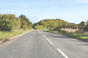 What do the long white lines along the centre of the road mean?