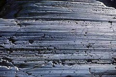 <p>Long parallel scars in rocks carved by rock fragments being dragged across them by a glacier.</p>