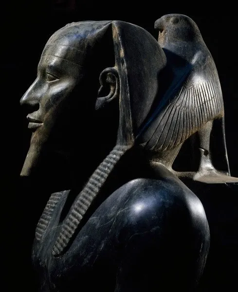 <p>Short Answer: Explain the significance of the statue pictured below, including identifying the pharaoh and god pictured, and briefly discussing what it can tell us about Egyptian art, religion, and/or kingship.</p>