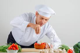 <p>The cook is preparing some food.</p>