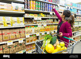 <p>The woman is reaching for an item.</p>