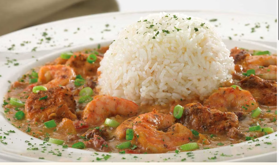 <p>Shrimp, Chicken, Andouille Sausage, Tomatoes, Peppers, Onions and Garlic Simmered in a Spicy Cajun Style Broth with Cream. Topped with Steamed White Rice</p>