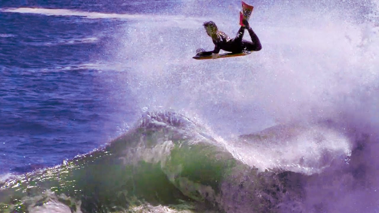 <p>Riding waves on a small board</p>
