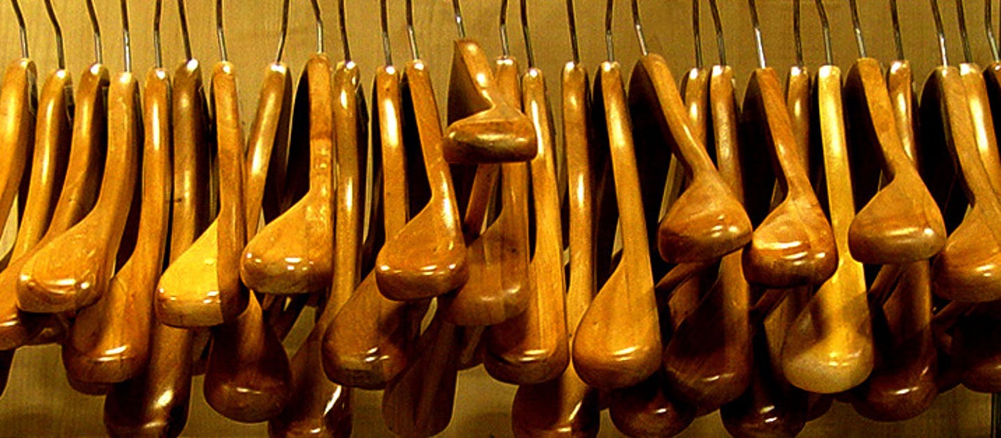 <p>A curved piece of wood, wire, or plastic with a hook at the top, used to hang up clothes.</p><p>Example: I need a few more clothes hangers for my jackets.</p>
