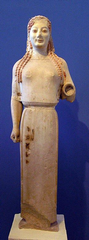 <p>Archaic sculpture of young woman, free-standing rigid, clothed</p>