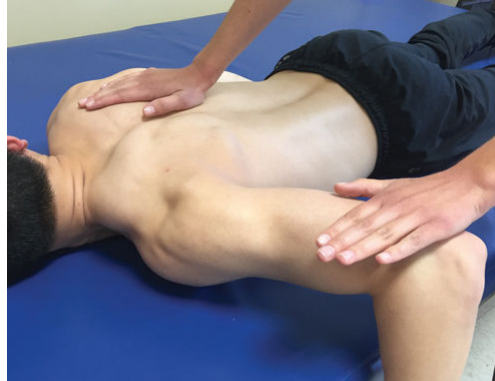<p>prone w/ shoulder abducted to 90 degrees and externally rotated, elbow flexed 90 degrees. put one hand on distal humerus (just proximal to elbow), other on other shoulder</p><p>“raise your elbow towards the ceiling, don’t let me push it down”</p>