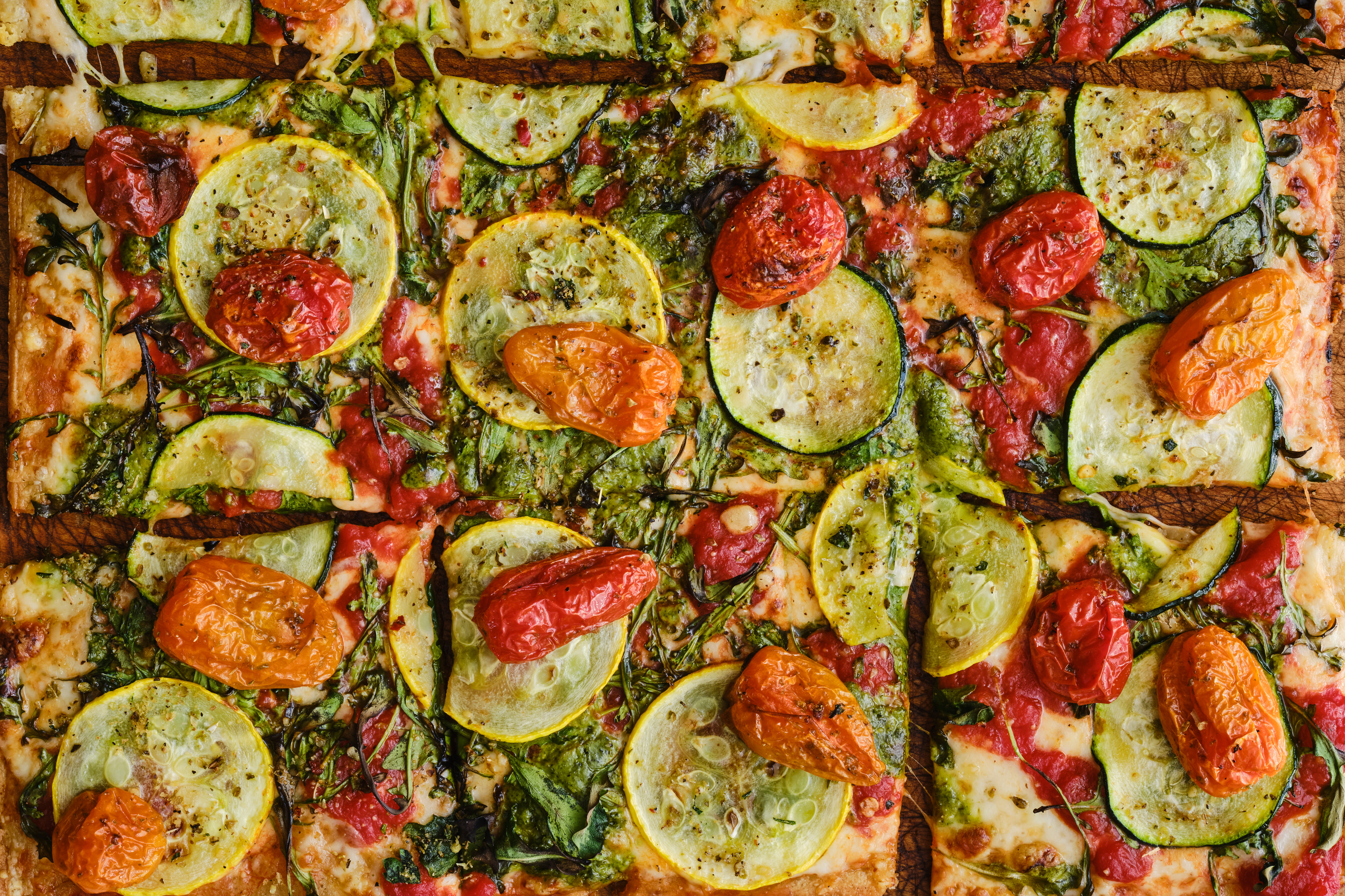 <p>A summer pizza you won't want to miss. Roasted summer squash, San Marzano tomatoes, fontina and mozzarella cheese, creamy pesto, arugula, and blistered cherry tomatoes, finished with our super secret pizza seasoning.</p><p>Guests can select if they would like it sliced or not sliced</p><p>Modification options: None</p><p>Allergens: Dairy, Seeds (sunflower), Garlic</p>