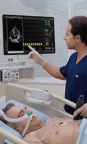 <p>He is checking information on the monitor.</p>