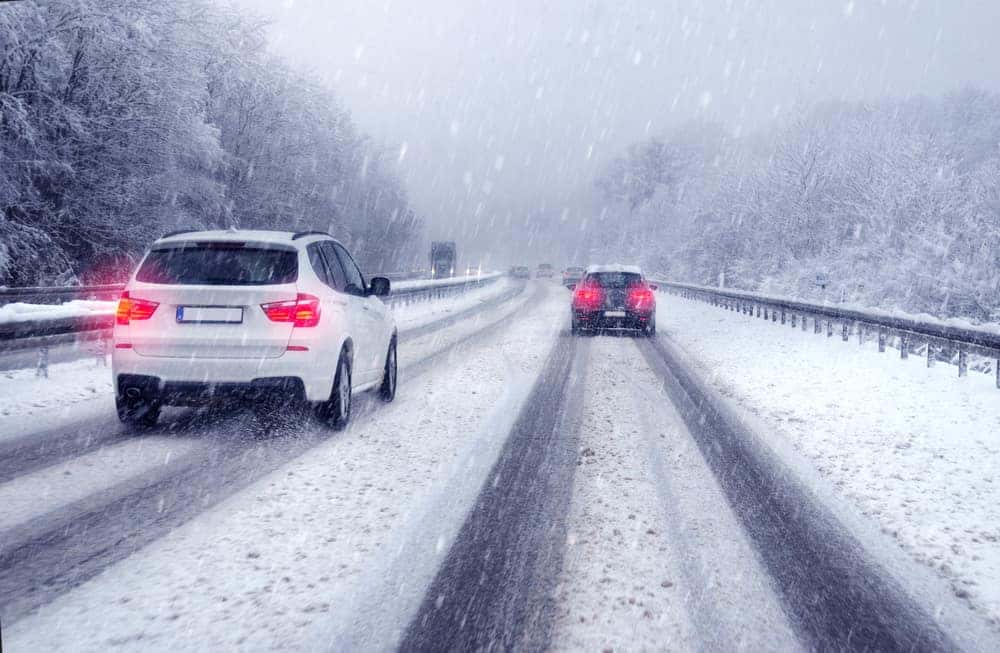 <p>When there is packed snow on the road, how much should you reduce your speed by?</p>