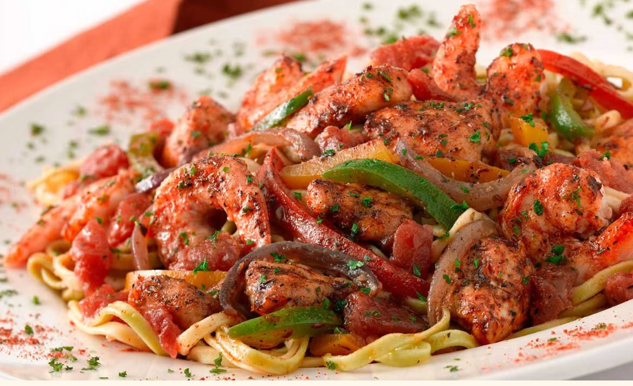 <p>Shrimp and Chicken Sauteed with Tomato, Onions and Peppers in a Very Spicy Cajun Sauce. All on Top of Fresh Linguini</p>