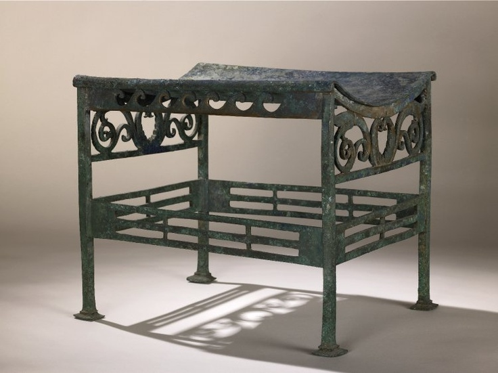 <p>The Background of</p><p><em>Roman Bronze Stool from Pompeii</em></p><p>1<sup>st</sup> century B.C.E.</p><p>Bronze</p>