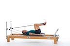 <p><strong>Setup</strong></p><ul><li><p>Lying supine in neutral spine position, hips externally rotated, feet in straps, dorsiflexed, heels together, hips and knees at 80 degrees</p></li><li><p>Resistance: light to medium | <strong>Springs:&nbsp;1R +1B</strong></p></li></ul><p><strong>Movement</strong></p><ul><li><p>Exhale: Straighten legs</p></li><li><p>Inhale: Open legs</p></li><li><p>Exhale: Bend legs, bring heels together, return to start position</p></li><li><p>Inhale: Pause</p></li></ul><p><strong>Muscle Focus</strong></p><ul><li><p>Hip adductors</p></li><li><p>Spinal flexors</p></li><li><p>Spinal extensors</p></li></ul><p><strong>Objectives</strong></p><ul><li><p>Hip adductor strength</p></li><li><p>Hip adductor stretch</p></li><li><p>Pelvic lumbar stabilization</p></li></ul><p><strong>Cues</strong></p><ul><li><p>Keep heels squeezing together as legs straighten</p></li><li><p>Keep carriage still as legs bend in from open position</p></li><li><p>Maintain pelvic lumbar stabilization</p></li></ul><p></p>