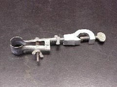 <p>holds a test tube to a ring stand</p>