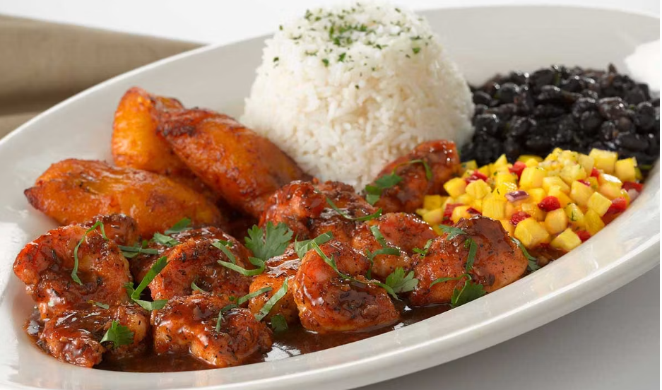<p>Sauteed Shrimp with a Very Spicy Jamaican Black Pepper Sauce. Served with Rice, Black Beans, Plantains and Marinated Pineapple</p>